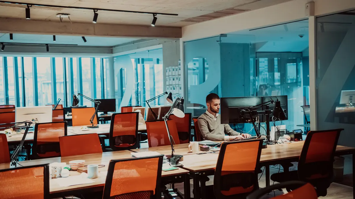 Portrait of Stylish Business person Works on Computer