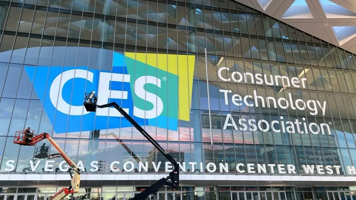 Photo of a large glass-front building signed as the Las Vegas Convention Center, with CES logo.