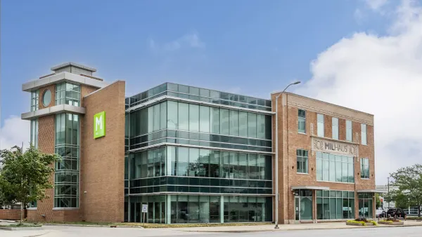 Picture of a brick building with an M logo
