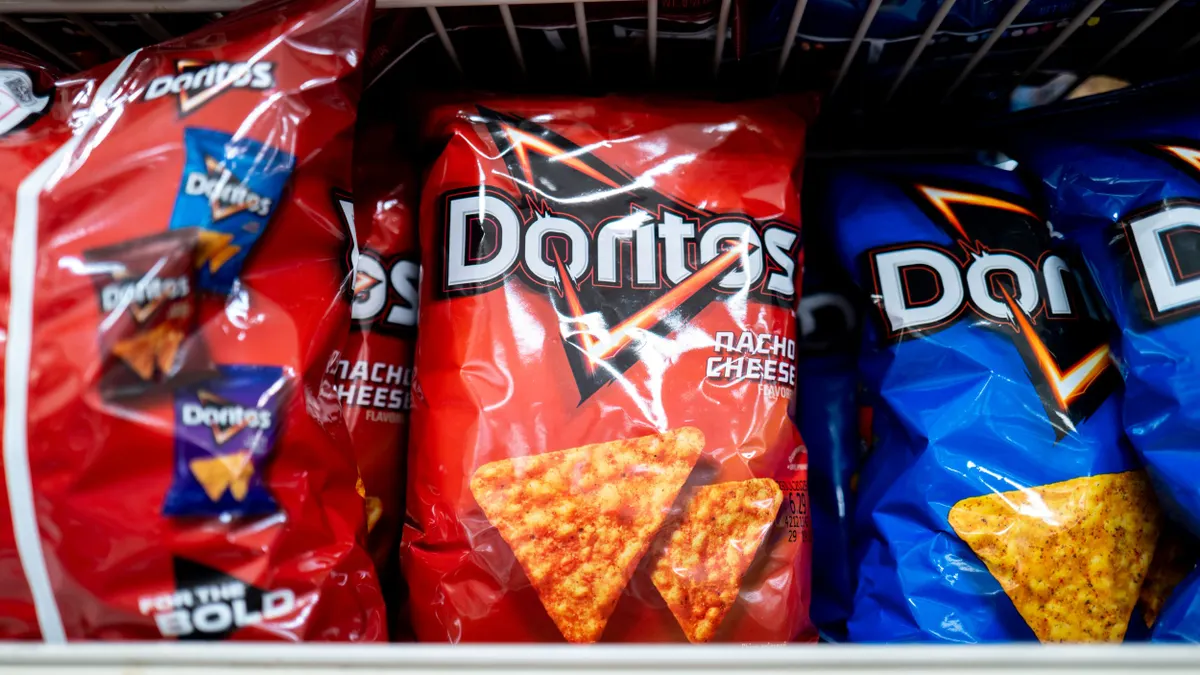 A shelf of bags of Doritos.