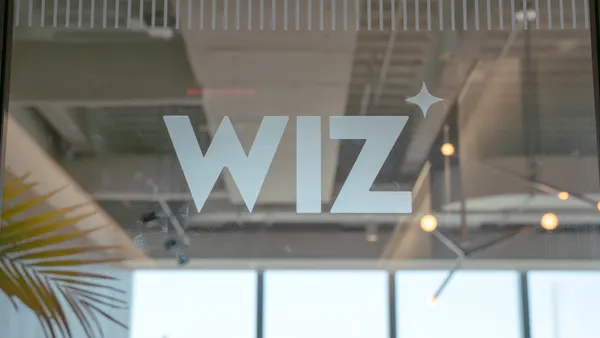 The word "Wiz" is spelled out in brushed-gray letters on a glass door