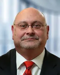 Headshot of a man in a suit.