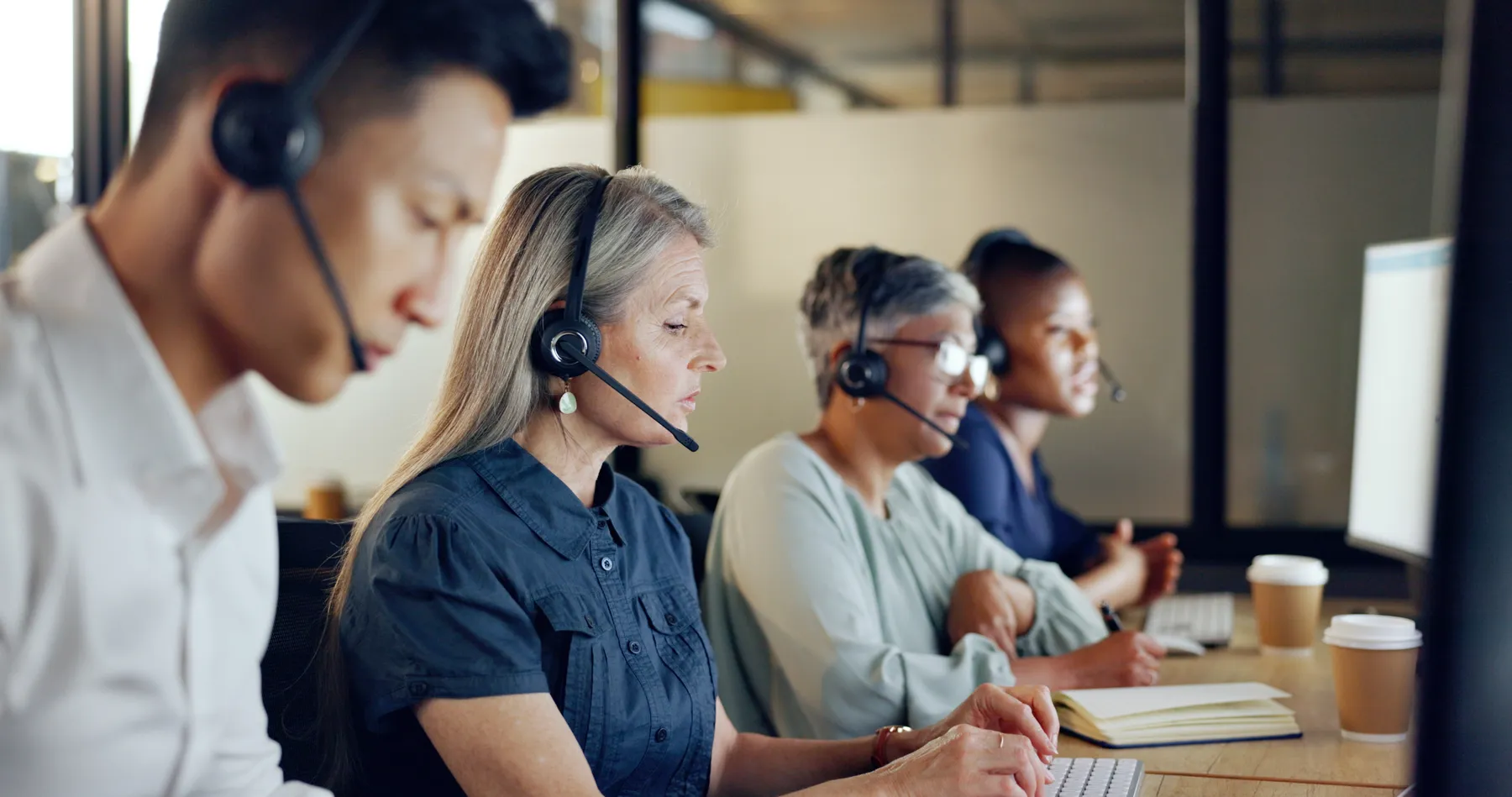 Call center agents handle customer service at desks