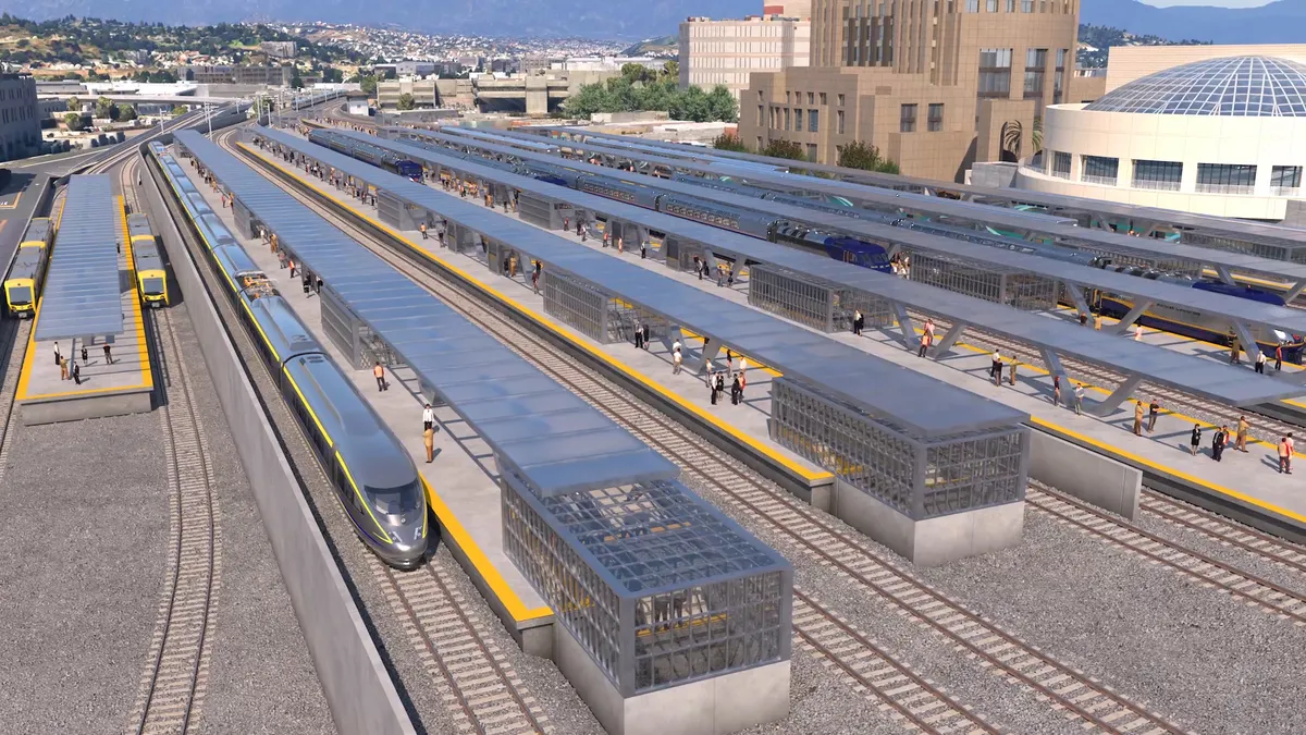 Artist's rendering of an aerial view of an open-air train station with multiple tracks and a sleek high-speed train stopped at a platform.