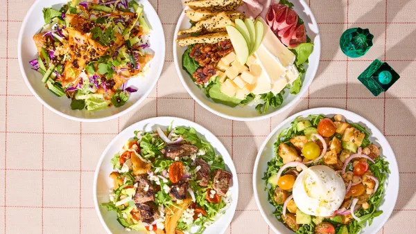 A photograph of four salads on a checkered table.