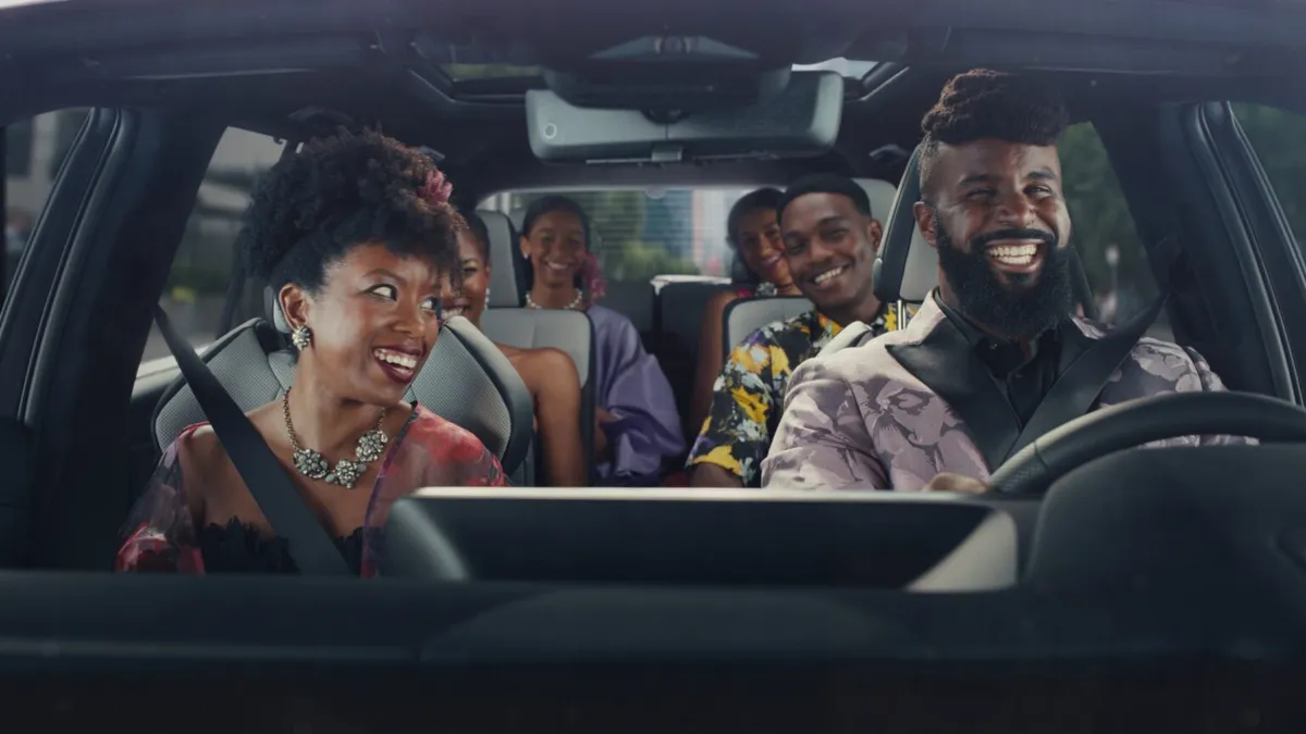 A family driving in a Lexus TX crossover SUV, as depicted in a campaign promoting the vehicle.