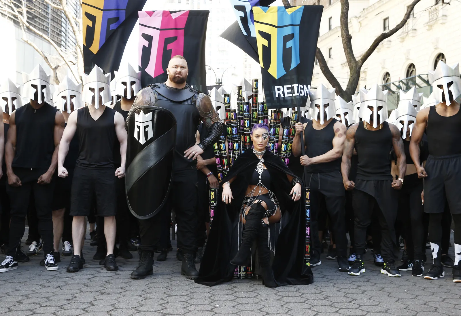 World’s Strongest Man and Game of Thrones star Hafþór Júlíus Björnsson and Fitness Expert and former WWE star Natalie Eva Marie in front of thrones made of Reign cans.