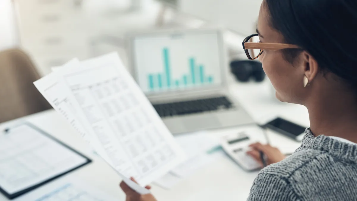 A businesswoman calculating finances in an office