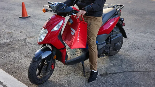 A DoorDash delivery worker on his motorcycle.