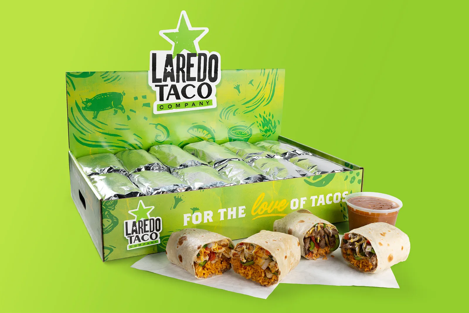 A photograph of a box of Laredo Taco burritos against a green background. The box says Laredo Taco Company. For the Love of tacos.