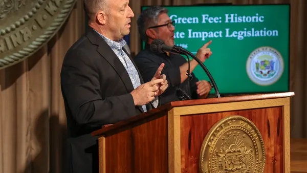 Hawai'i Gov. Josh Green speaks behind a podium