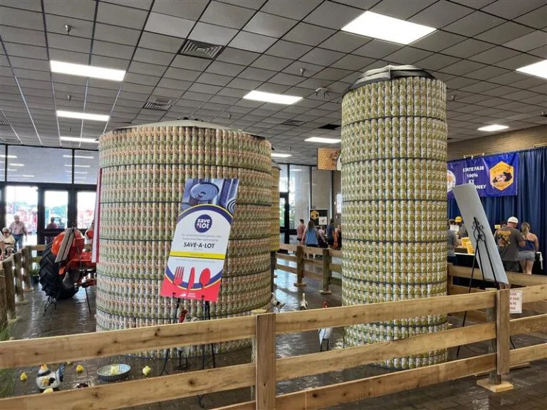 Two sculptures made out of thousands of cans of food.