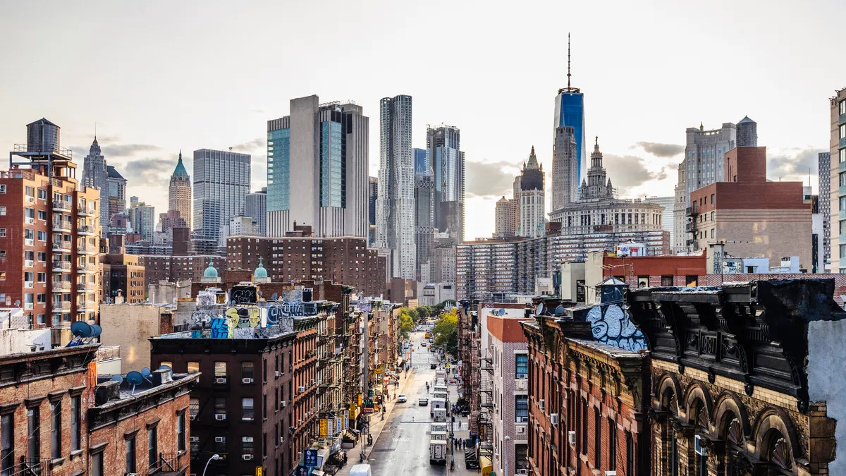 Lower Manhattan cityscape, with Chinatown in foreground and Wall Street in the background.