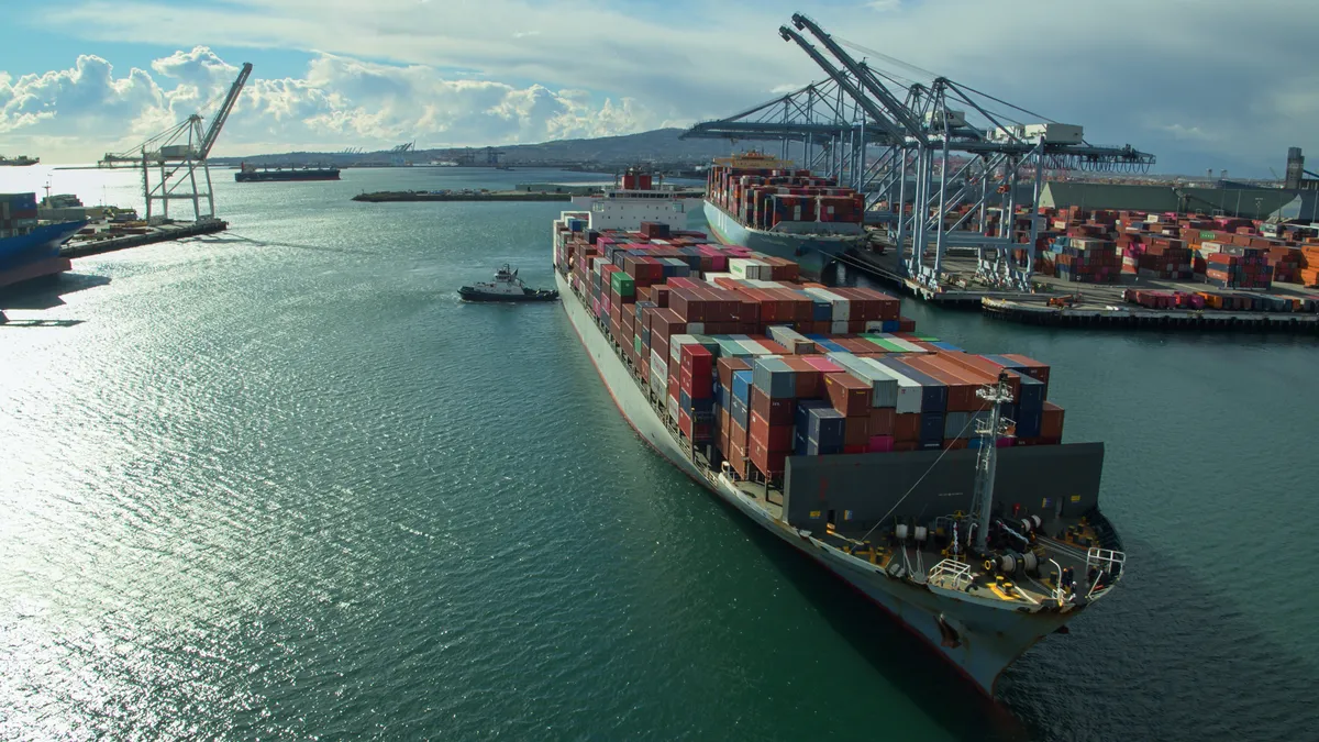 Drone shot of a massive container ship arriving in the Port of Long Beach, California.