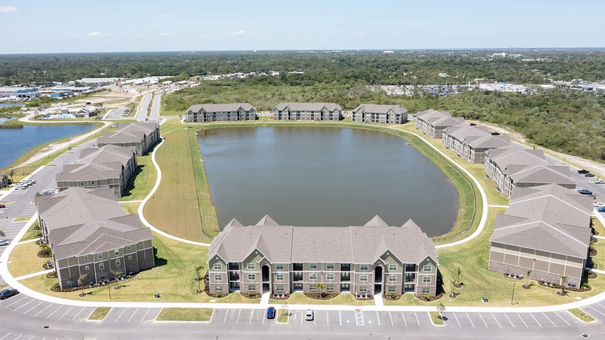 Aerial view of multiple apartment buildings around water