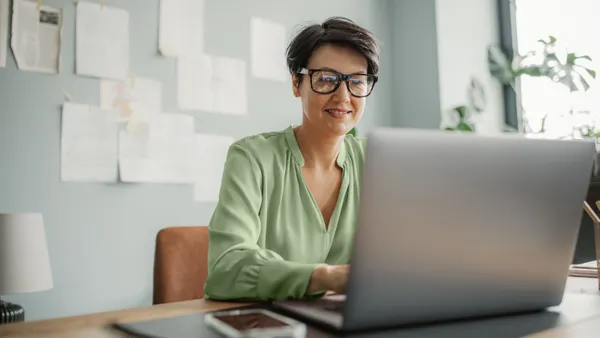 Mature woman at home working remotely at home office
