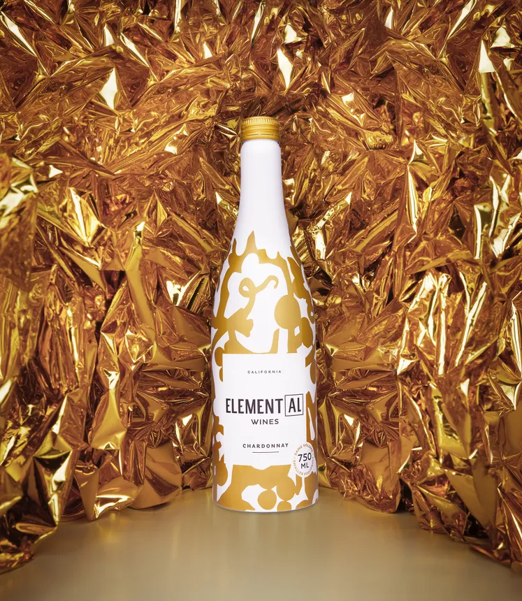 A bottle of Element[AL] wine in a white and gold decorated metal bottle.