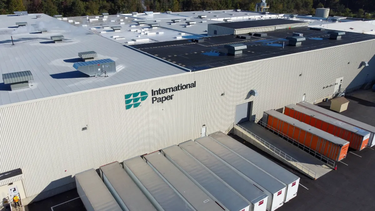 Aerial view of an industrial facility with an International Paper sign on the outside.
