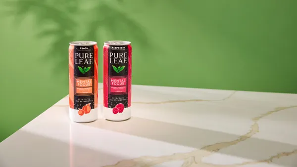 Two cans of Pure Leaf Mental Focus sit on a marble counter top.