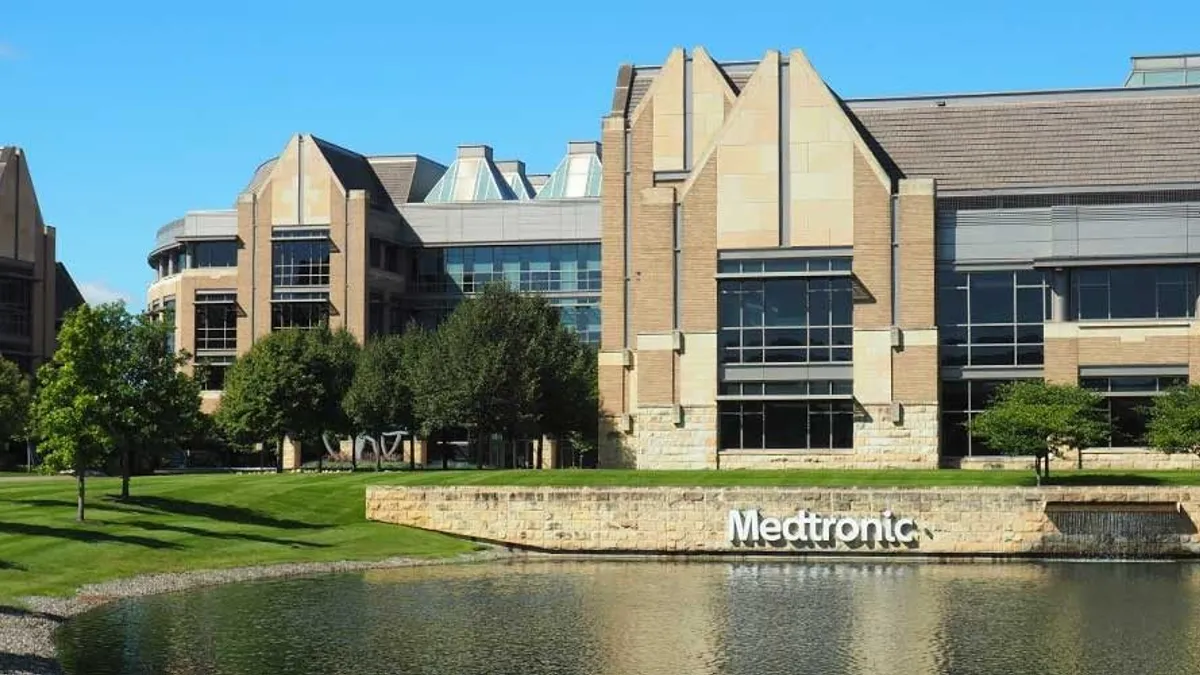 A building in front of a lake with the words 'Medtronic' on a sign.