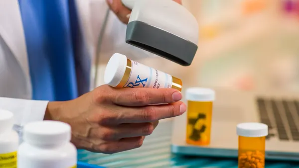 pharmacist scanning prescription