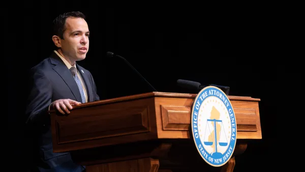 New Jersey Attorney General Matthew Platkin speaks at a lectern.