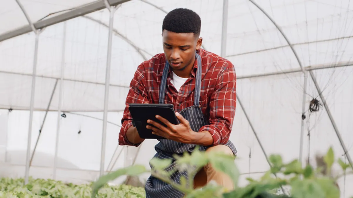 farmer in greenhouse with tablet for inspection, harvest and sustainability with checklist