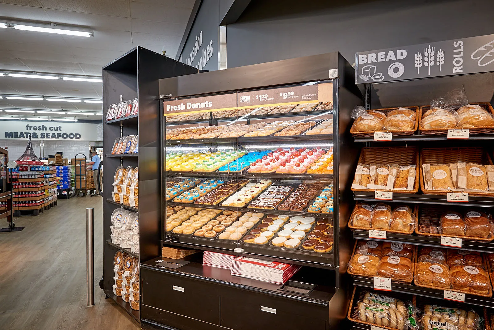 Grocery store display of donuts and bread