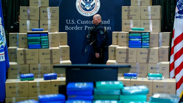 A police officer walks near cocaine seized from a cargo ship at a Philadelphia port during a news conference at the U.S. Custom House on June 21, 2019 in Philadelphia, Pennsylvania.