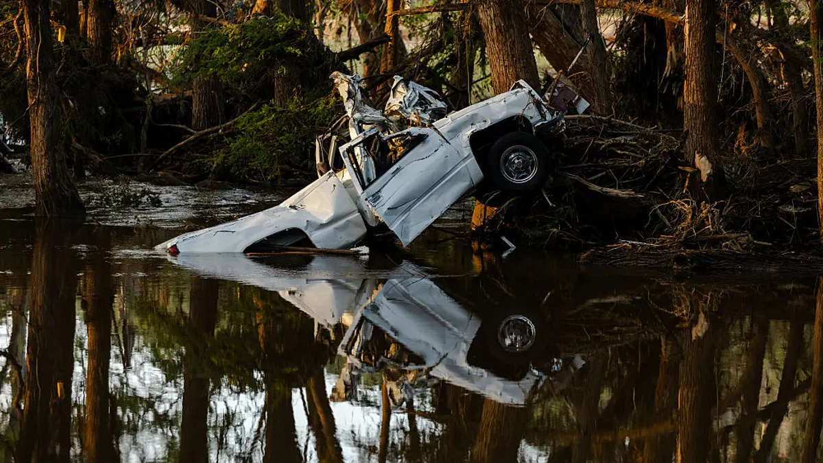 A pickup truck severely crushed in the wake of catastrophic flooding in Texas.