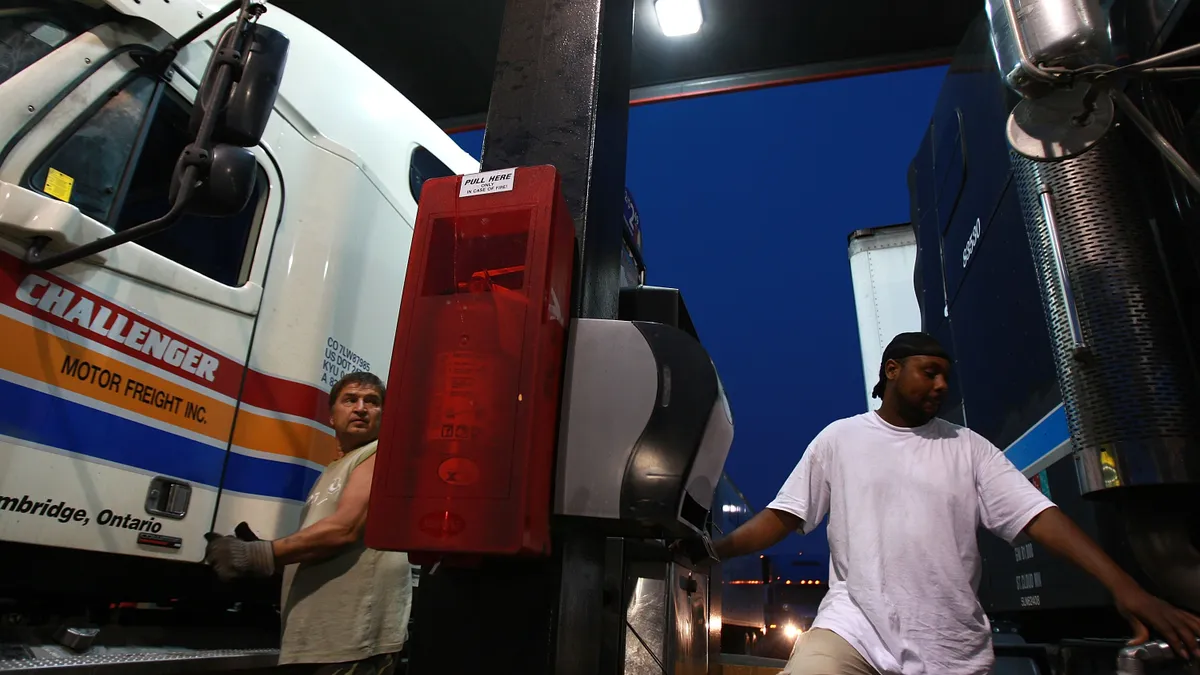 Drivers fill up their trucks at a gas station in Milford, Connecticut.