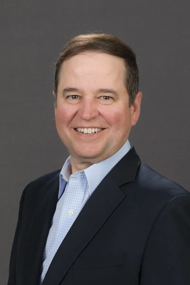 Headshot of a man in a suit