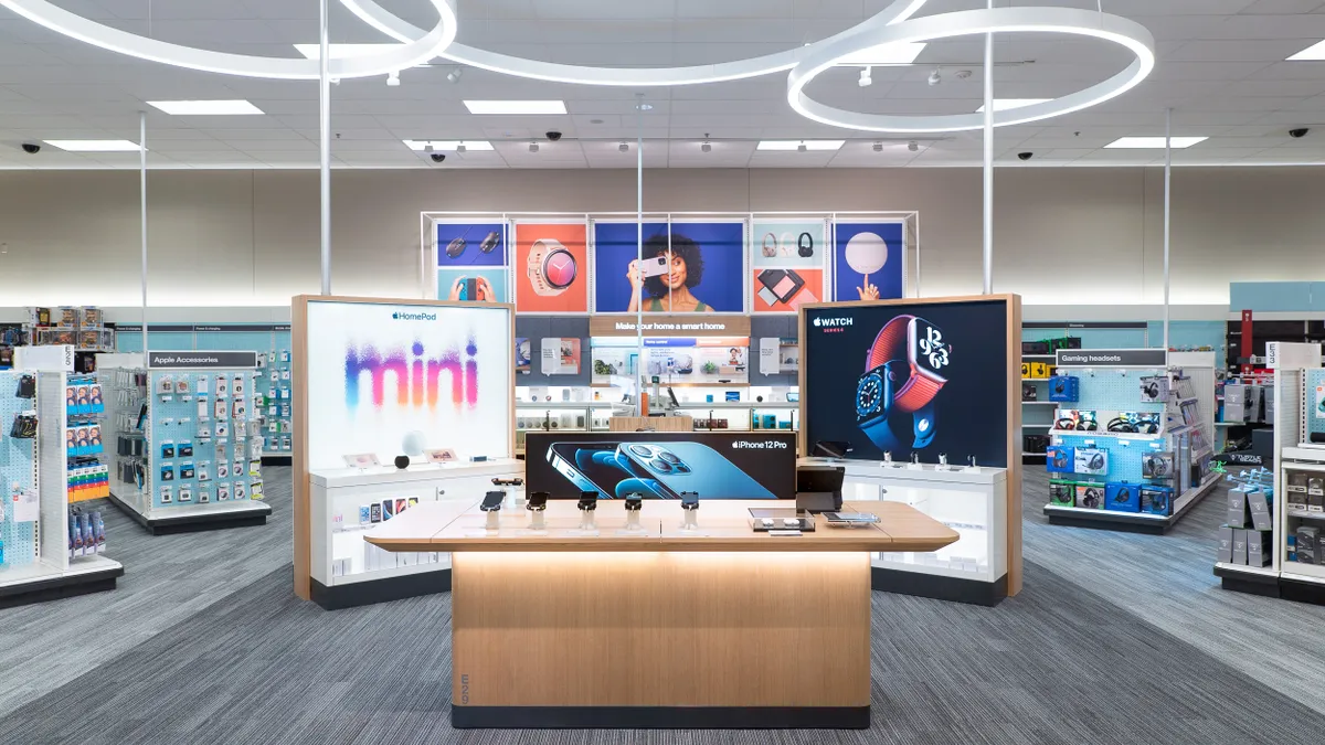 Multiple tech displays inside an Apple shop-in-shop at a Target store.