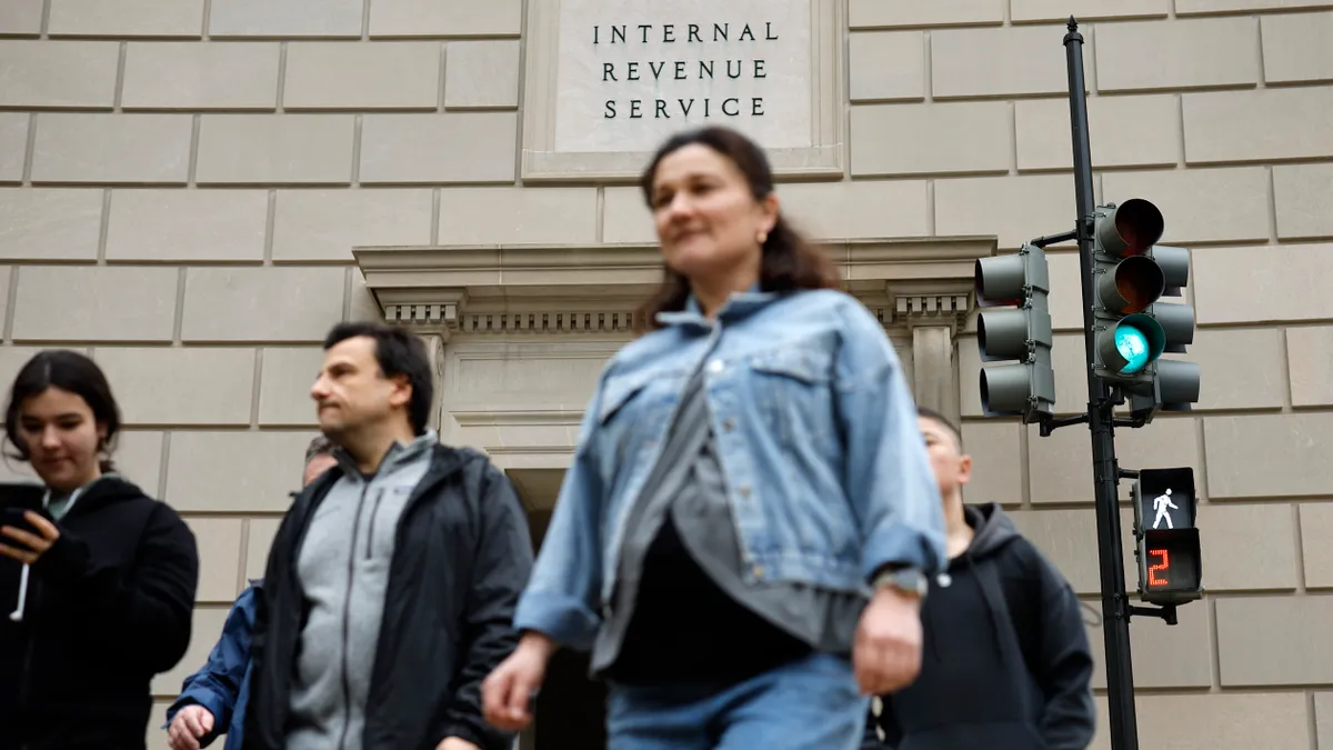 Tourists walk past the headquarters of the Internal Revenue Service near the National Mall on April 7, 2023 in Washington, DC.