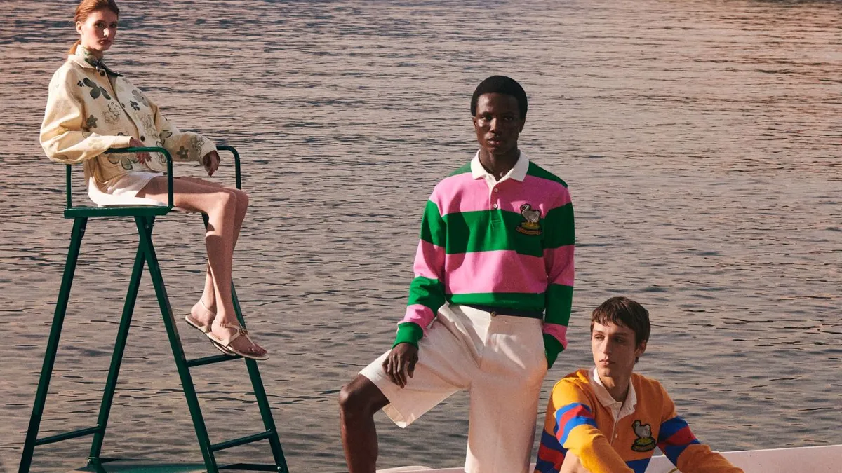 Three models are on a boat on a lake, wearing clothing from the Rowing Blazers and Gucci collab