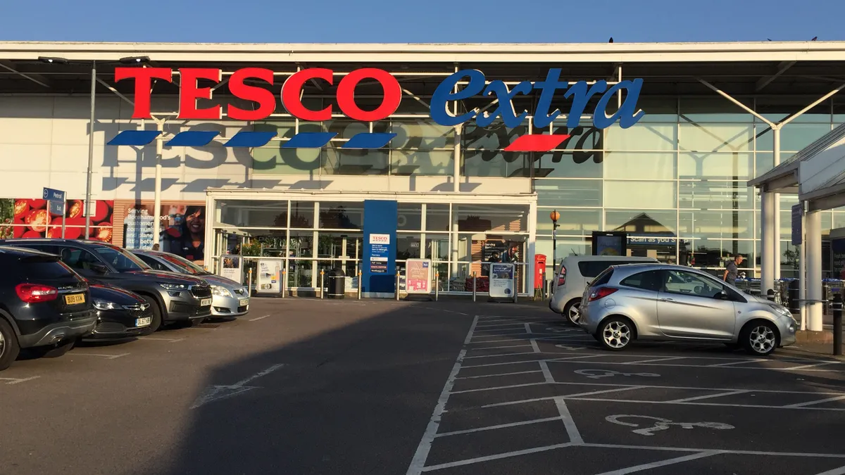 Exterior supermarket with cars in foreground