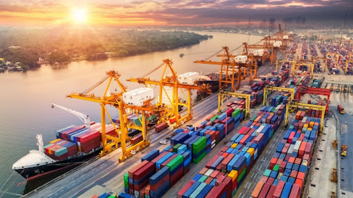 A birds eye view of a shipping port with a large crane and crates on a platform surrounded by a body of water