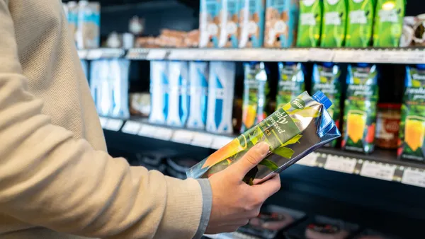 Shopper looking at product infront of a retail isle.