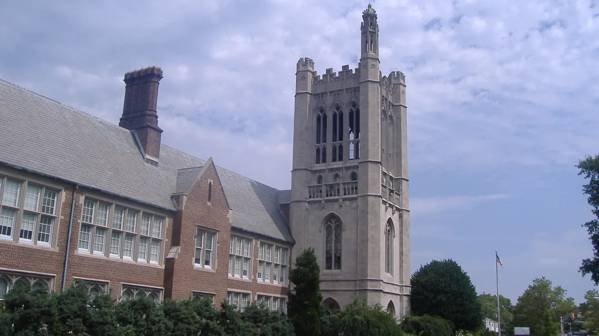 A gothic-style academic building sits in front of a well-manicure green lawn in New Jersey.