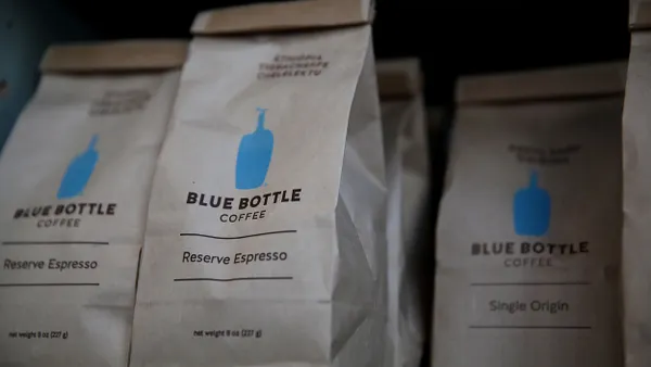 Bags of Blue Bottle coffee are on a store shelf