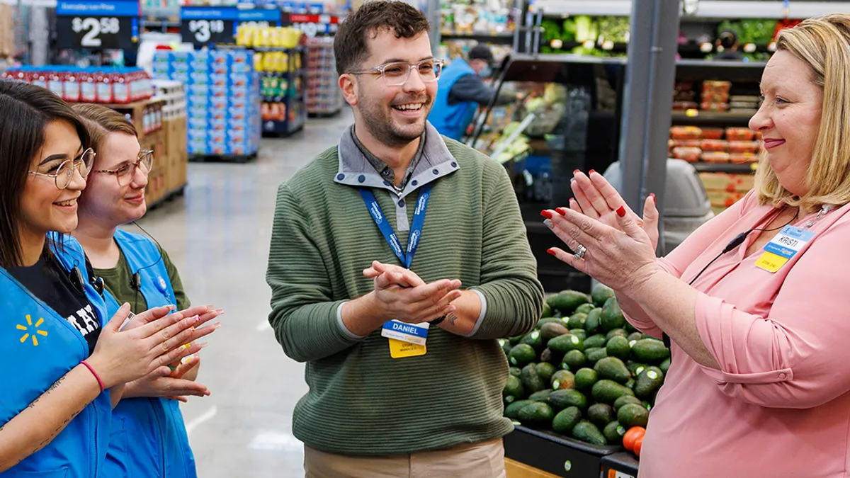 Four Walmart employees gathered in the store's produce section