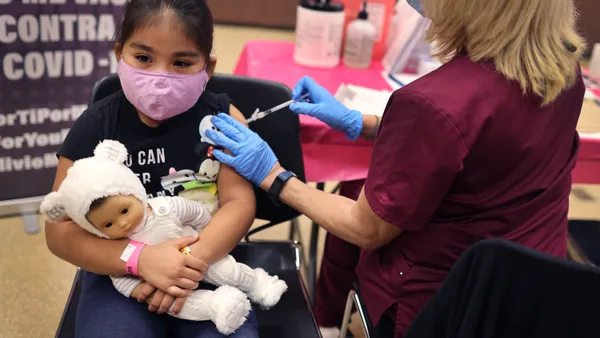 A 1st grade student receives a Covid-19 vaccine at in Chicago, Illinois.