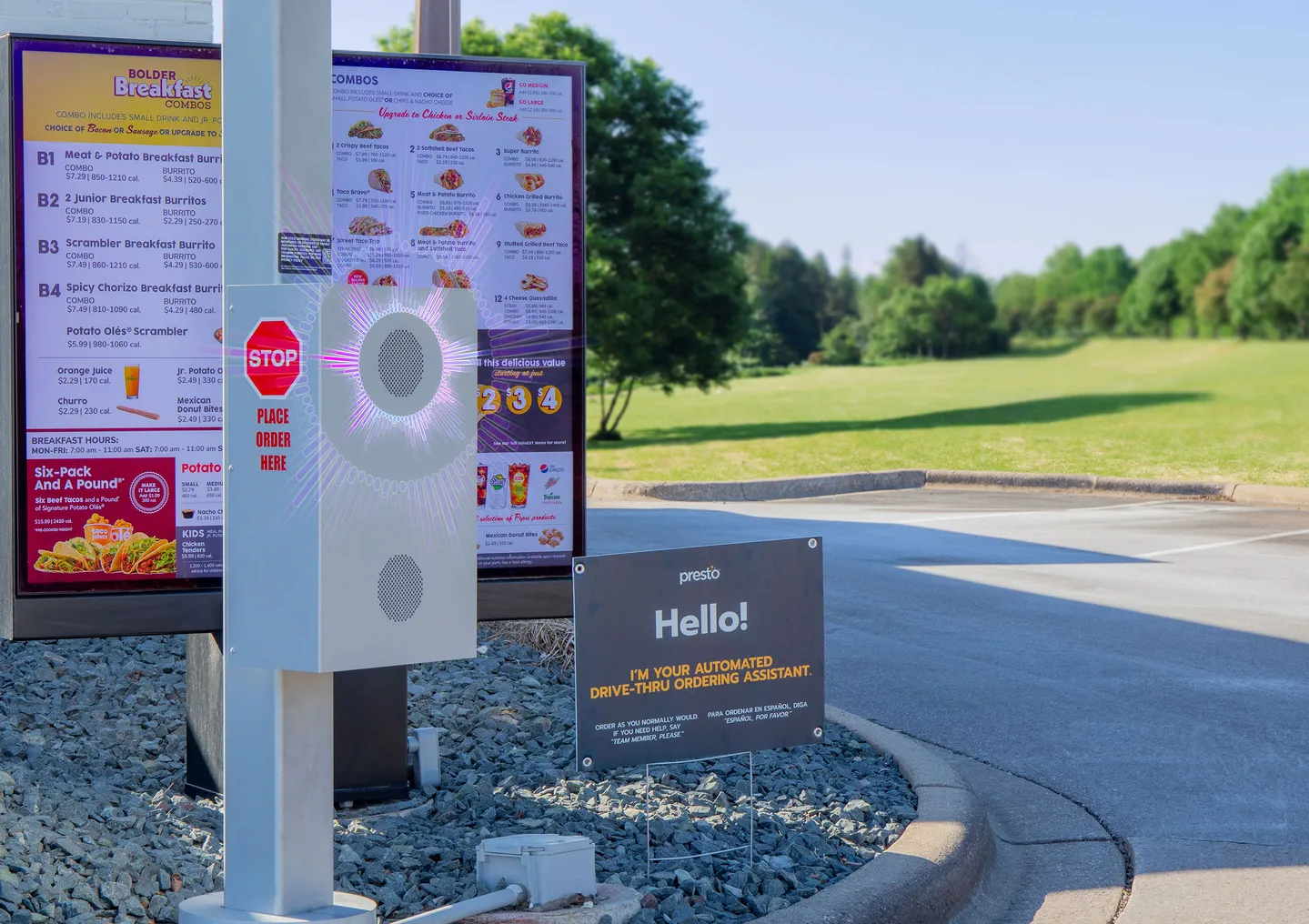 A drive-thru menu board with a speaker box at Taco John's