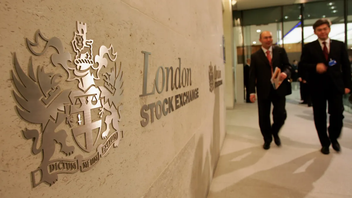 A photo people walking past the London Stock Exchange.