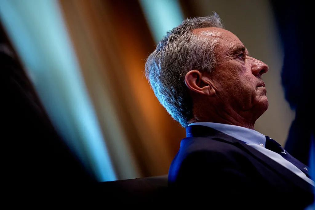Robert F. Kennedy Jr., wearing a dark suit, stares forward.