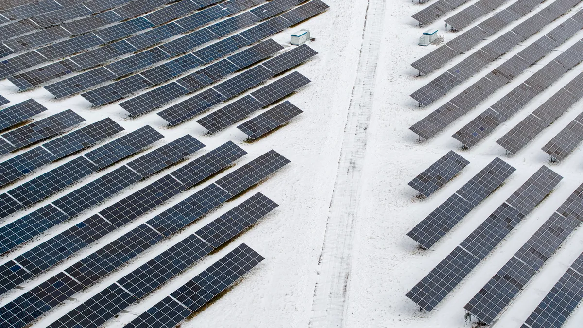 Big solar farm in the Appalachian Mountains, Pennsylvania, on a sunny winter day after a snowfall.