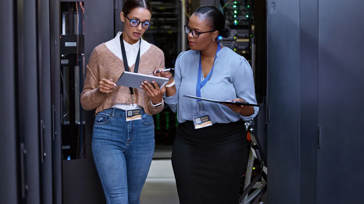 Cropped shot of two attractive young female computer programmers working together in a server room