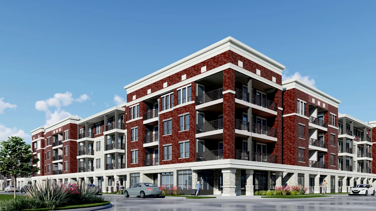 Four-story red brick apartment property with balconies.