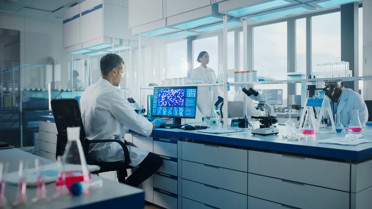 A group of scientists work at a life sciences lab.