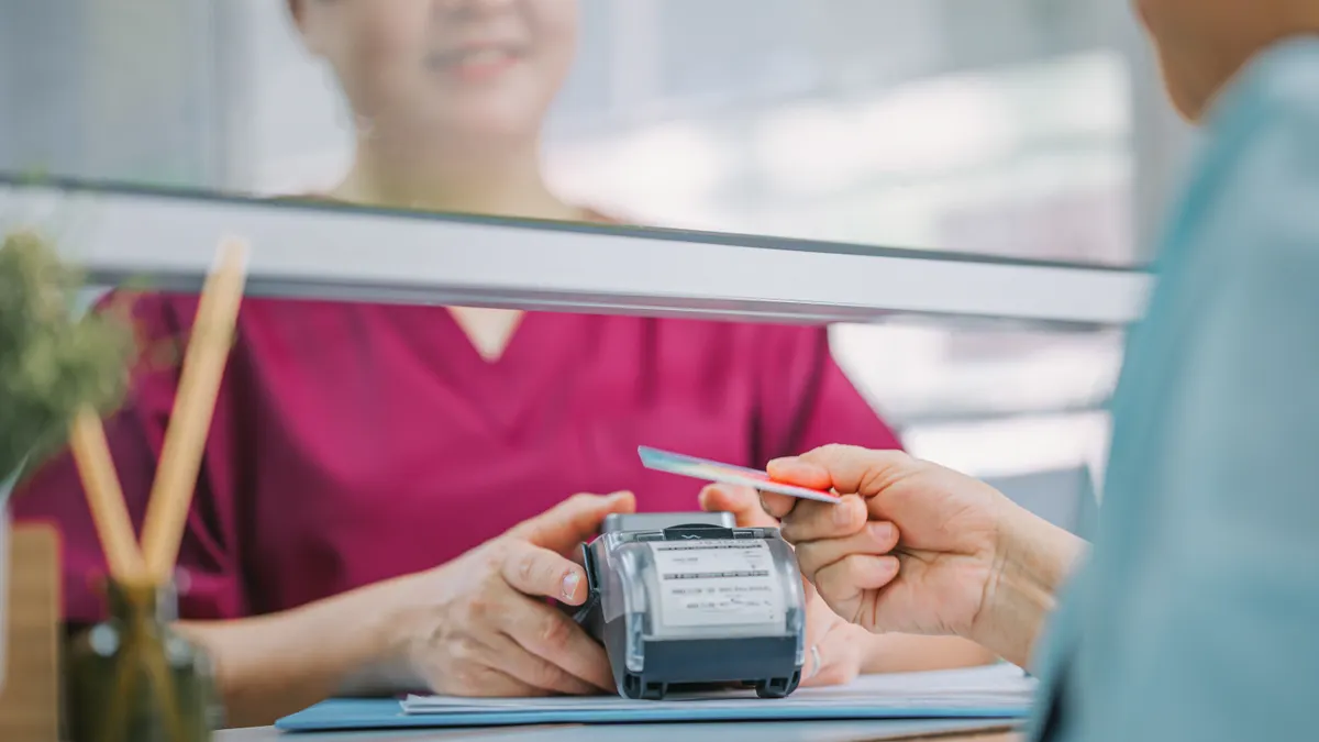 Asian Chinese Senior woman paying medical bill with credit card